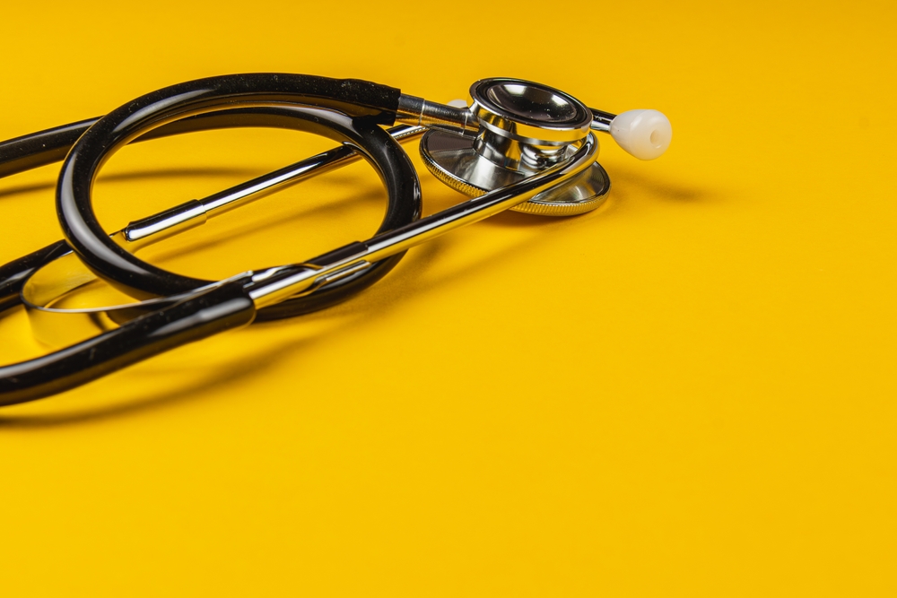 A,Stethoscope,Rests,On,A,Vibrant,Yellow,Surface,,Highlighting,Its