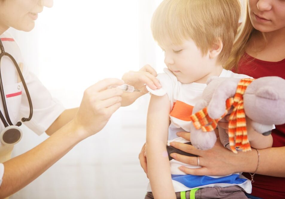 A,Doctor,Giving,A,Child,An,Injection,At,Home.